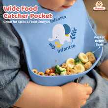 blue silicone baby bib with elephant design and 5cm deep wide food catcher pocket holding banana, broccoli, and cereal pieces.