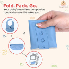 foldable silicone baby bib in blue, compact travel‑friendly design easy to pack in pouch or backpack.